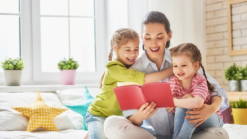 mom reading a book to kids photo