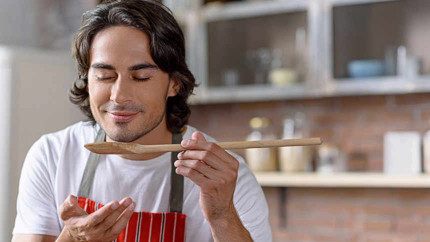 man smells the aroma of food photo